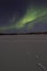 Northern lights activity over frozen lake