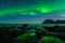 Northern lights, Aurora Borealis, with the Dragon Eye in the foreground, Uttakleiv Beach, Lofoten, Norway