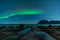 Northern lights, Aurora Borealis, with the Dragon Eye in the foreground, Uttakleiv Beach, Lofoten, Norway