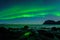 Northern lights, Aurora Borealis, with nice reflection at the Uttakleiv Beach, Lofoten, Norway
