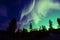 Northern lights aurora borealis in the night sky over beautiful lake landscape