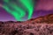 Northern lights aurora borealis in the night sky over beautiful lake landscape