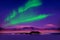 Northern lights aurora borealis in the night sky over beautiful lake landscape