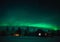 Northern lights Aurora Borealis over cottage in Lapland village. Finland