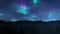 Northern lights aurora borealis over forest mountain range, 4K