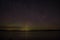 Northern lights aurora borealis over pond in Latvia