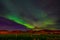 Northern lights Aurora borealis reflection across a lake in Iceland