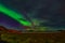 Northern lights Aurora borealis reflection across a lake in Iceland