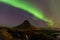 Northern lights or Aurora dancing with fully of stars on the sky of Iceland mountain landscape.