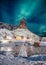 Northern lights over mountain with colors scandinavian village at Lofoten