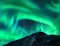 Northern lights and silhouette of woman with raised up arms