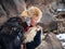 Northern Mongolia. Portrait of a boy with a hunting golden eagle. Eagle hunters are individuals who train and hunt with golden