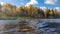 Northern nature. Autumn. Storm in Sunny weather. Wave to lake forest on the background of autumn