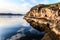 Northern polar summer. Beautiful coastline of Barents sea, rocks reflecting in the calm water surface. Arctic ocean