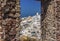 The northern tip of Oia, Santorini framed by a stone window in Oia castle