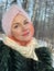 Northern Woman with a scarf on her head, cold north, Siberian weather. Red cheeks from the cold.