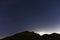 Northumberland night sky over Northumberlandia with stars, cloud and light pollution