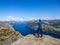 Norway - Boy standing on a steep cliff with the view on Lysefjorden