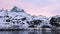 Norway. Breathtaking view of high mountain rocky peaks covered with white snow. Panoramic landscape of Lofoten fjords in