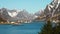 Norway. Breathtaking view of high mountain rocky peaks covered with white snow. Panoramic landscape of Lofoten fjords in