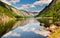 Norway Fjords with Still Reflecting Water and Green Mountain Valley