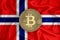 Norway flag, bitcoin gold coin on flag background. The concept of blockchain, bitcoin, currency decentralization in the country.