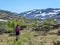 Norway - A girl with a hiking backpack on the trail trhough a highland plateau