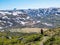 Norway - A girl with a hiking backpack on the trail trhough a highland plateau