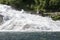 Norway-Hellesylt waterfall and traditional house with grass roof