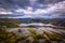 Norway- July 31, 2018: Traveler in the landscape near the Kjerag rock, Norway