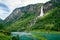 Norway landscape with waterfall in mountain river canyon.