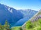 Norway - Lush green slopes of the fjord and clear water at the bottom of the valley