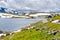 Norway mountain road with hut and glacial extra wide panorama