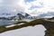 Norway mountain road with hut and glacial lake wide panorama