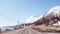 Norway, narrow roads of Lofoten on a spring day with snow on the mountains