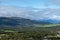 Norway nature landscape with beautifull clouds and green fields and pine forest.