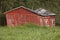 Norway. Red wooden rustic abandoned and curved farm house countryside