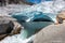 Norway Travel, Young Woman with a backpack admires Nigardsbreen Nigar Glacier arm of Jostedalsbreen located in Gaupne Jostedalen