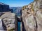 Norway - Young man squatting on Kjerag