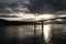 Norwegian fjord with a bridge, mountains and water, view from hurtigruten ship boat, norway, europe, sunset