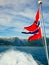 Norwegian flag against fjord mountains