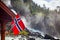 Norwegian flag against waterfall in Norway Scandinavia