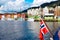 Norwegian flag on the background of the bay and the old wooden houses on the waterfront of Bergen