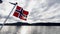 Norwegian flag on boat in the Osterfjord near Bergen in Norway in Autumn