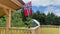 Norwegian flag is fluttering over wooden terrace. Waving flag in the breeze