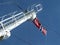 Norwegian flag swings in the wind from a ferry boat`s white tower high in the blue sky