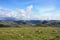 Norwegian lake, hills and green valley, cloudy sky