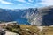 Norwegian landscape with mountains and lake. Picturesque view from pathway to Trolltunga attraction. Norway, Scandinavia