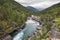 Norwegian landscape with river and forest. Slettafossen waterfall. Visit Norway