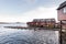 Norwegian old city A with reflections in water and cloudy sky, n